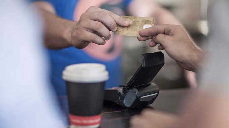 Alguien entrega una tarjeta de crédito como pago por el café