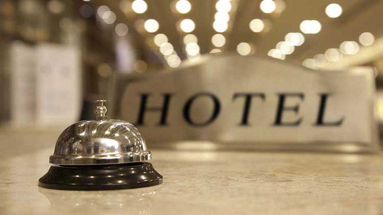 Hotel check in desk with a metal bell.